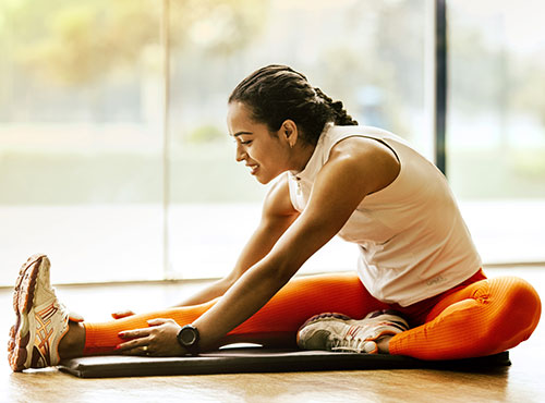 A woman is doing yoga on the floor